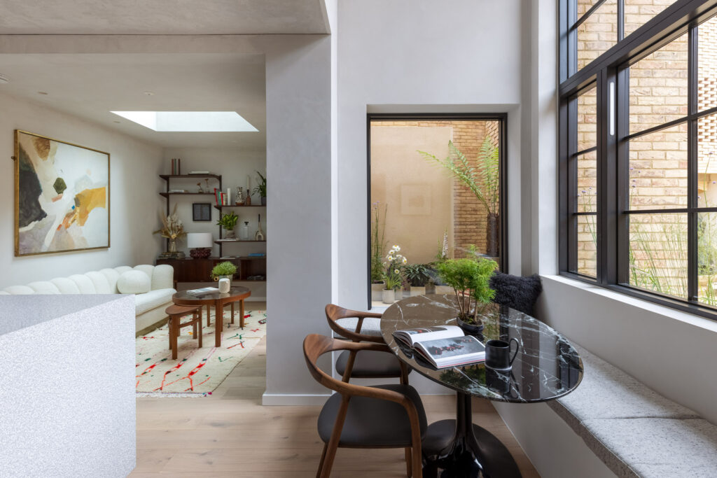This photo depicts a new build home with crittal-style windows and vast glazing, in answer to the question is buying a new build a good investment?